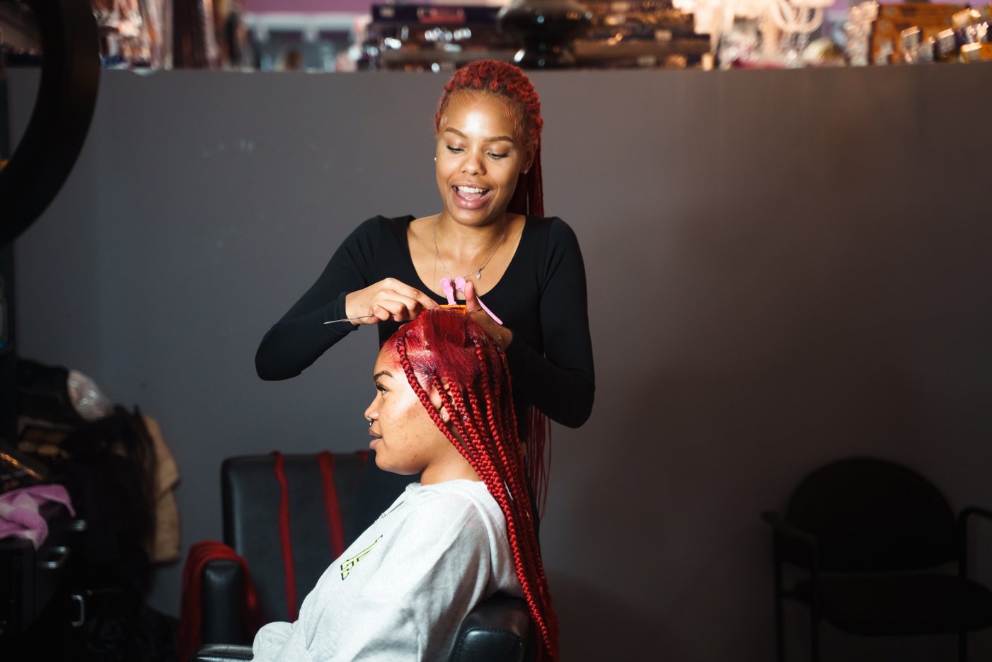 Stylist Braiding Hair in a Salon