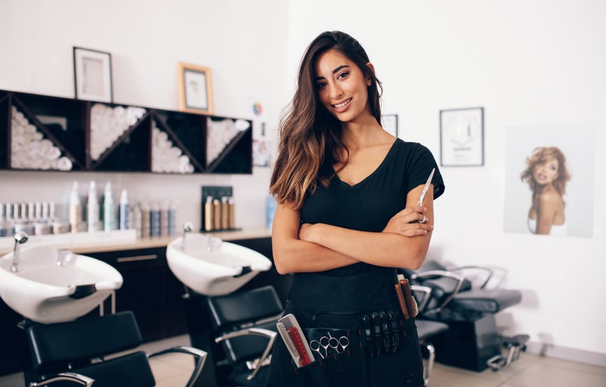 Female Hairdresser Standing in Salon