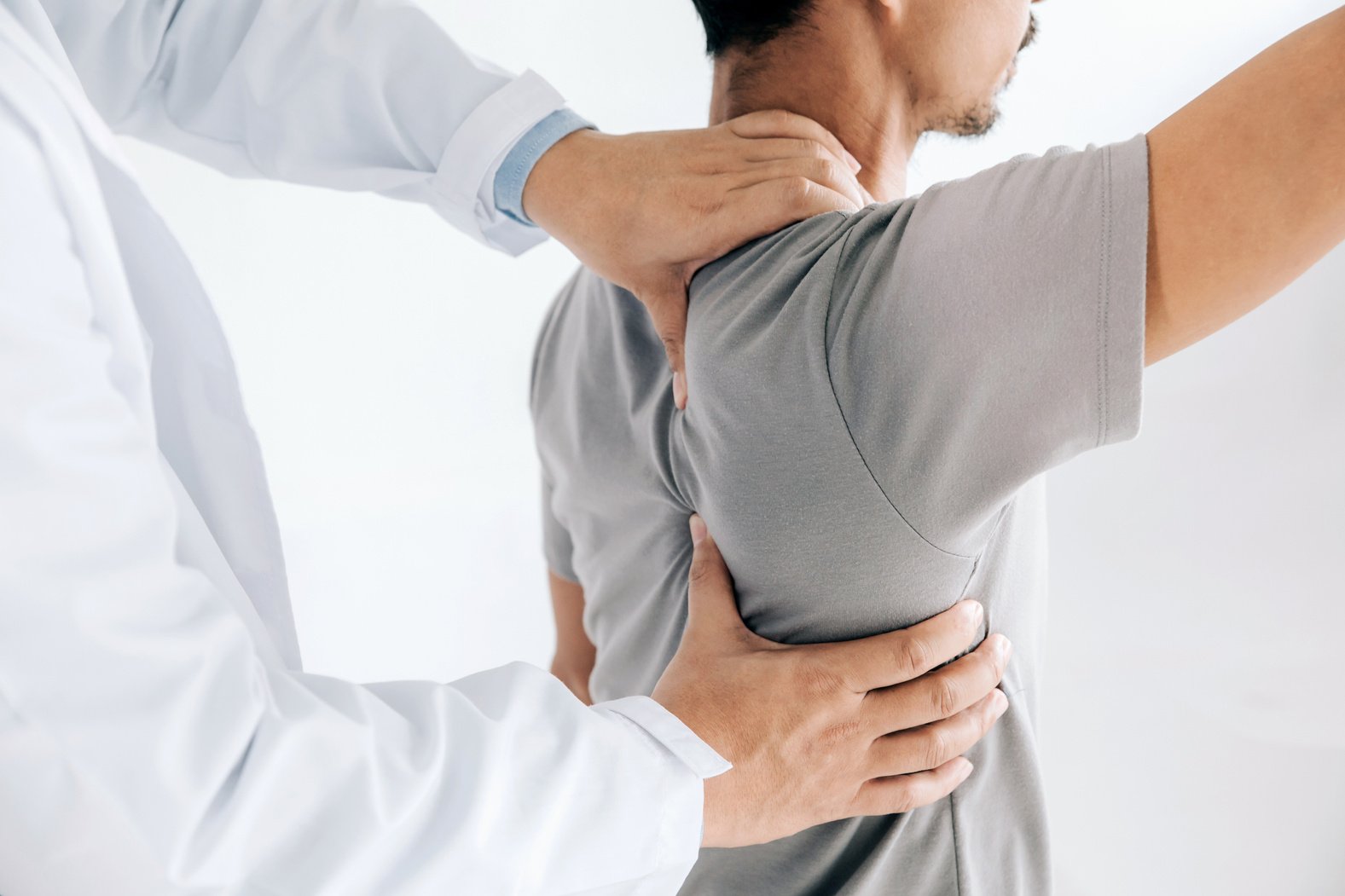 Physiotherapist Examining a Patient's Back