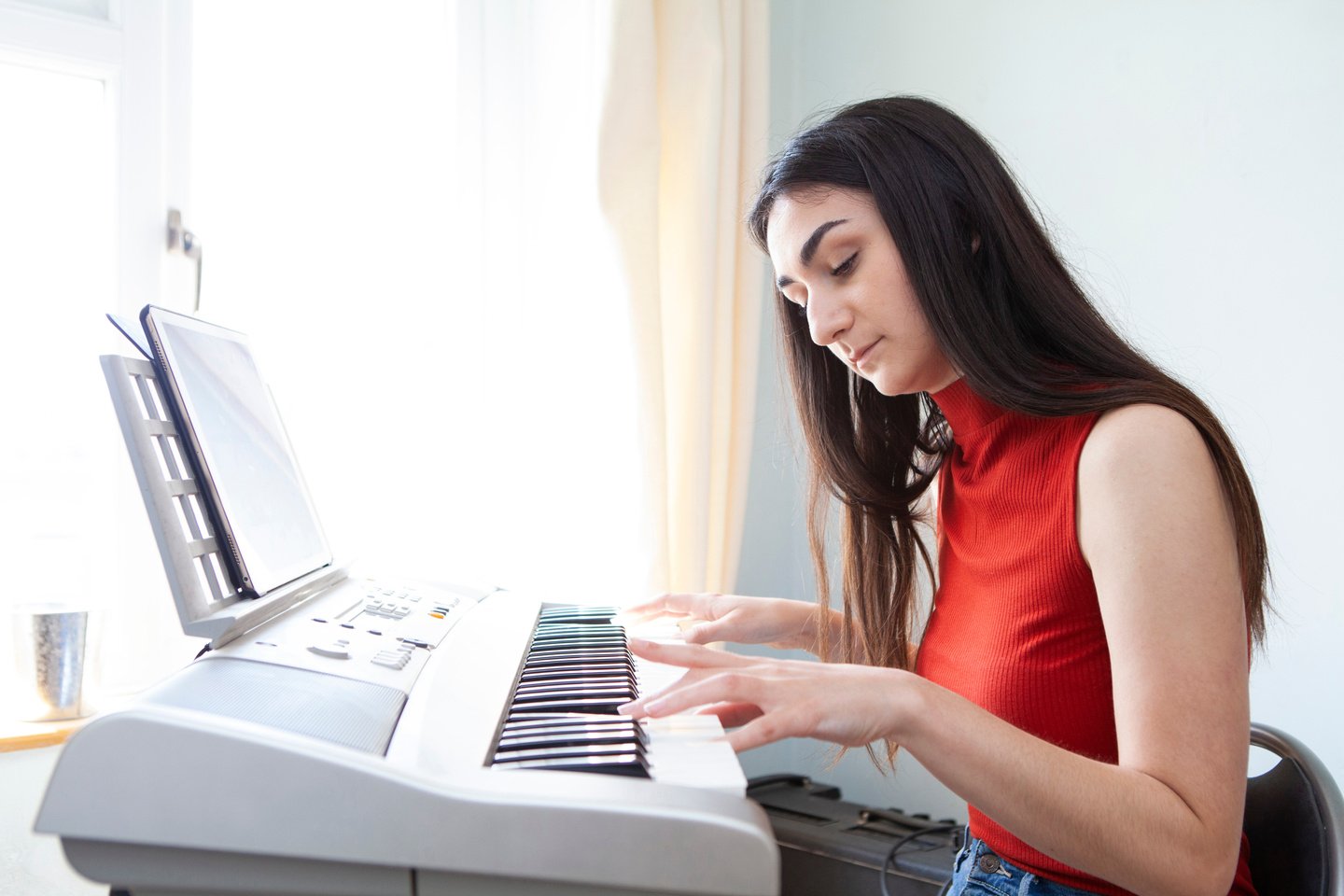 Teenager learning piano at home