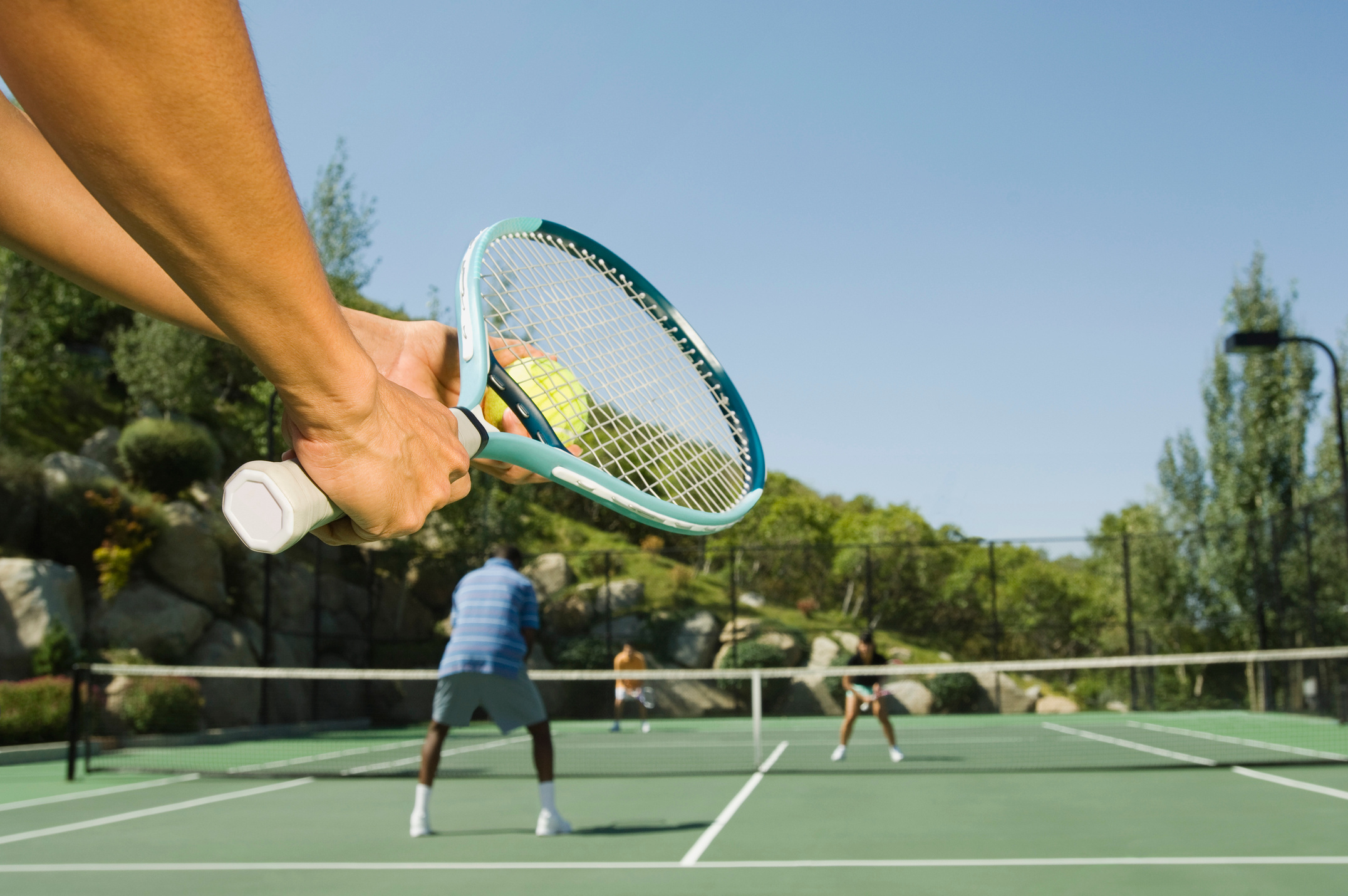 Tennis player serving tennis ball